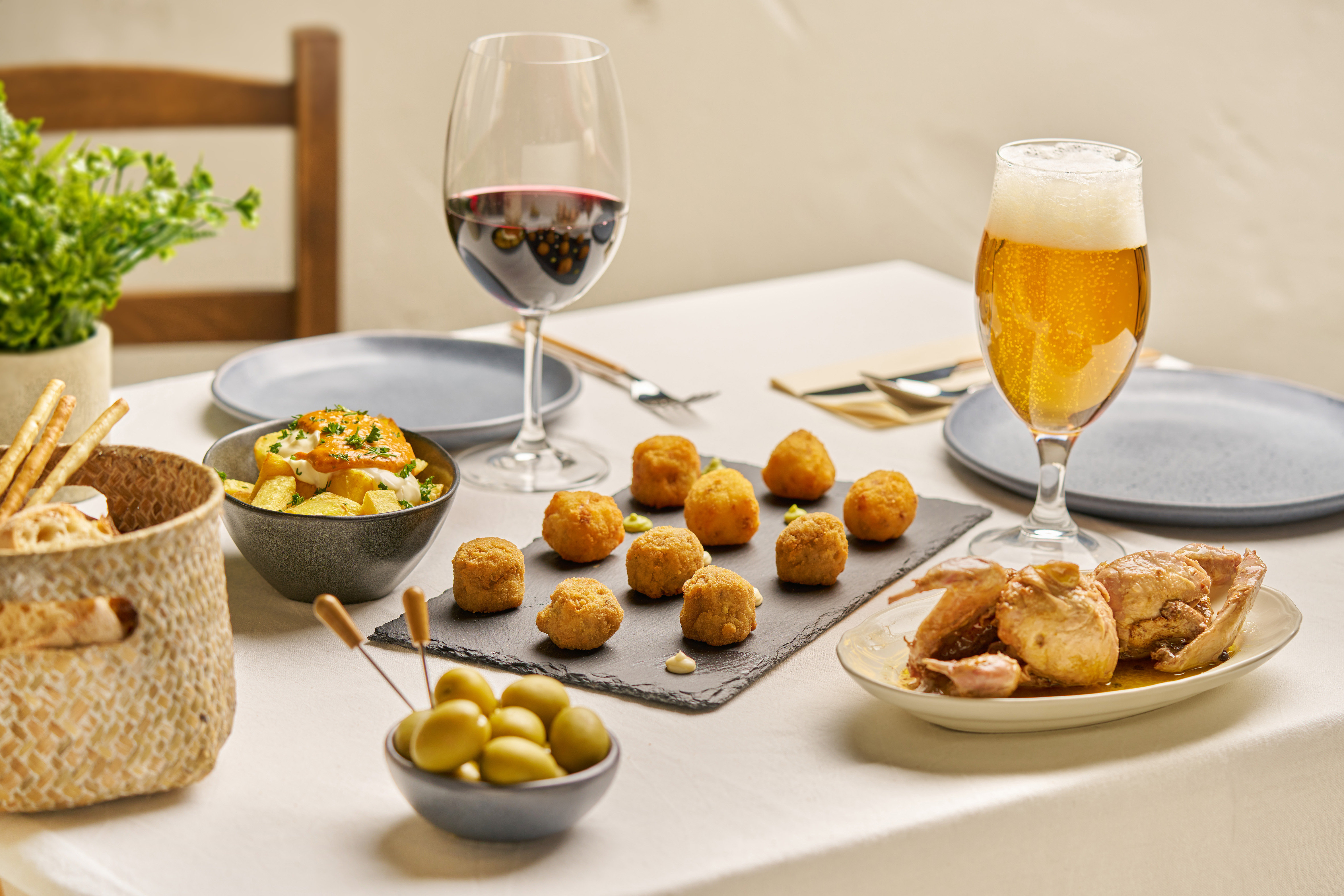 Premium croquetas served on slate with wine and tapas